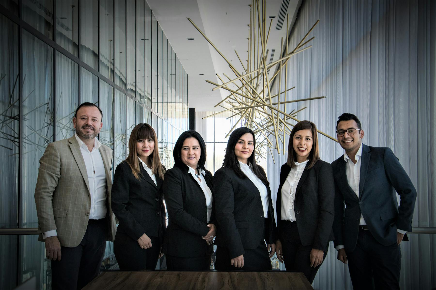 Professional team in suits standing in a modern office